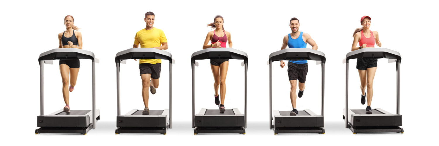 Full,Length,Portrait,Of,People,Running,On,Treadmills,In,A